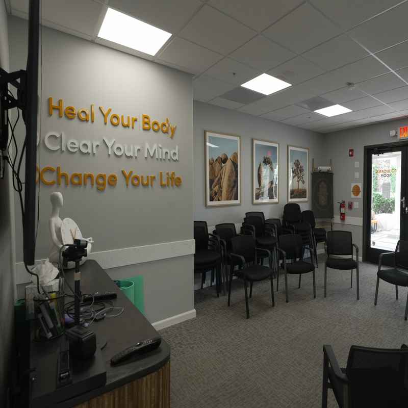 A bright, welcoming therapy room with a circle of chairs and wall art highlights the safe and supportive setting of PHP in Palm Springs.
